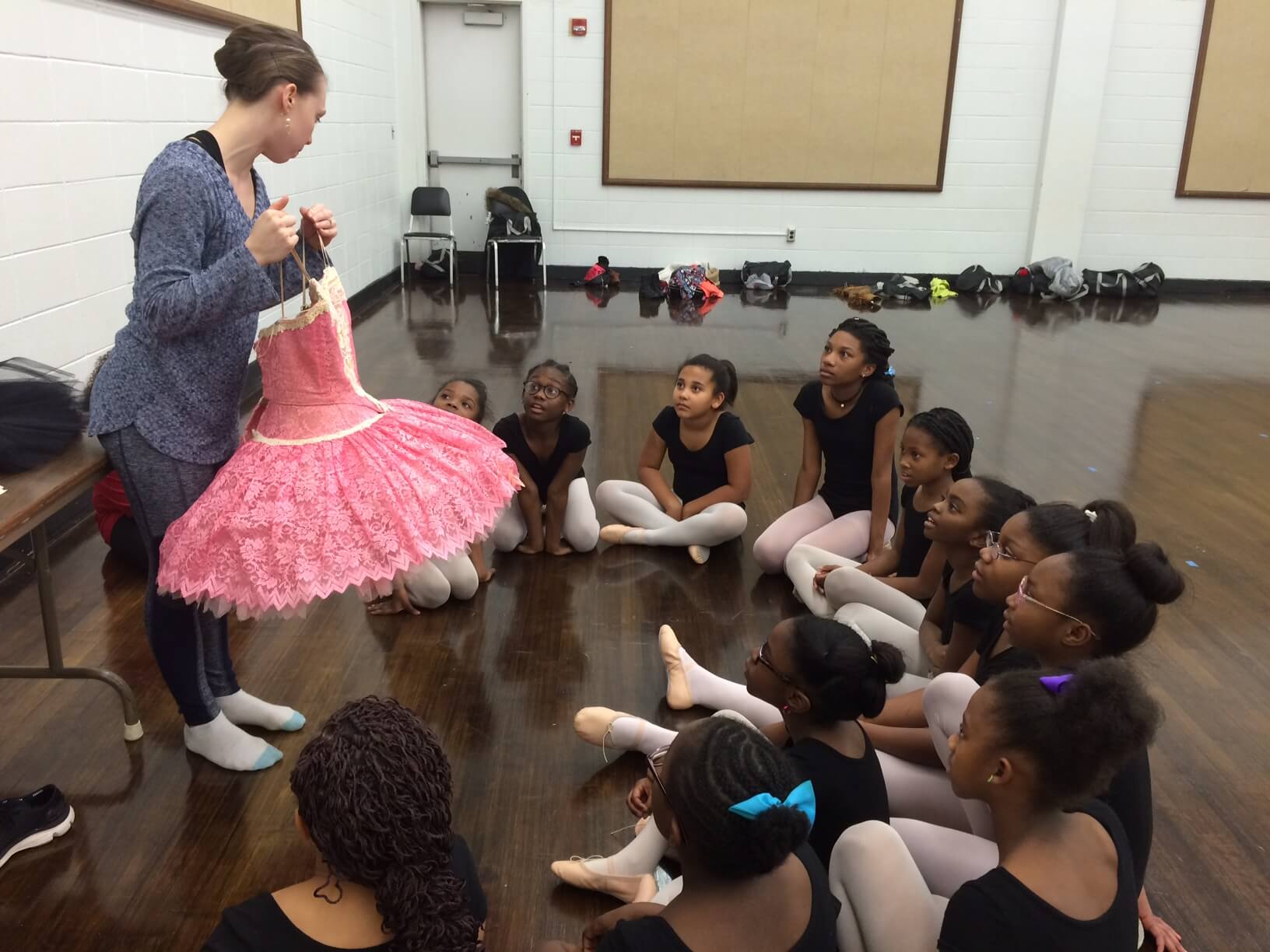 Instructor shows tutu to CityDance students